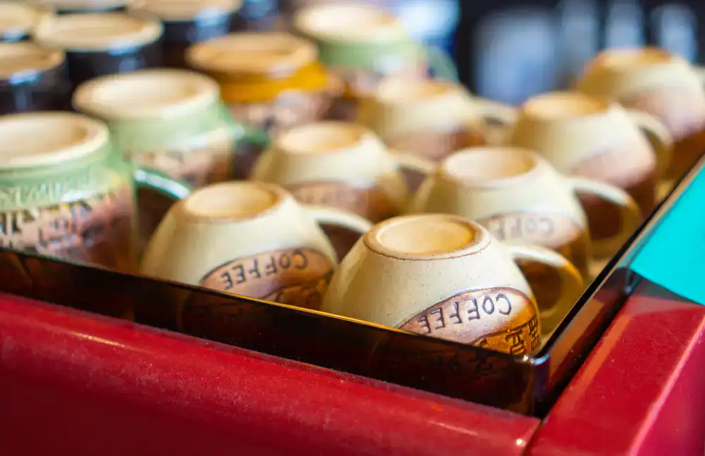Multiple coffee cupping bowls lined up for quality testing and tasting
